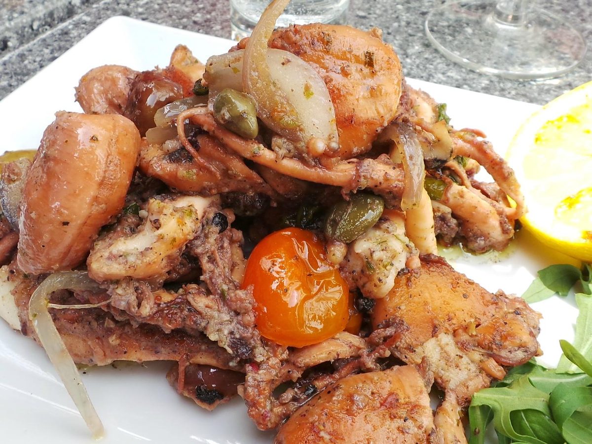 Grilled seafood platter with octopus, prawns and lemon